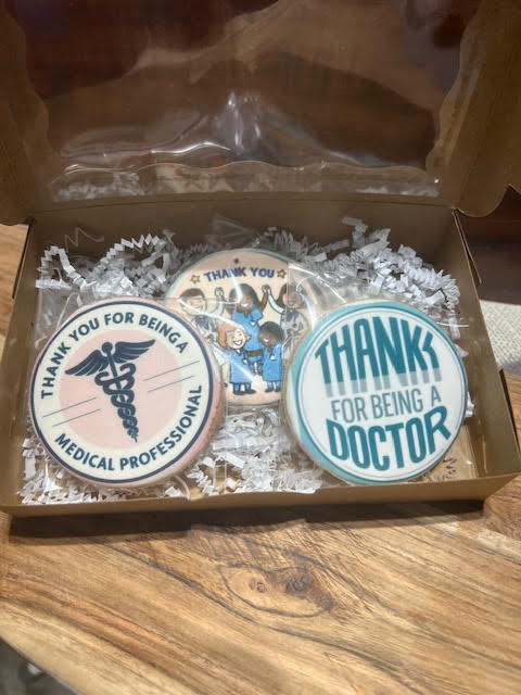 A box of cookies with thank you for being a medical professional on them.