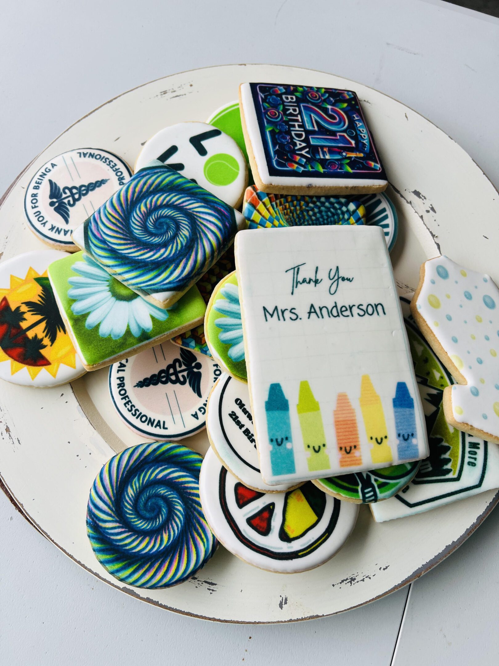 A plate of cookies with different designs on them.