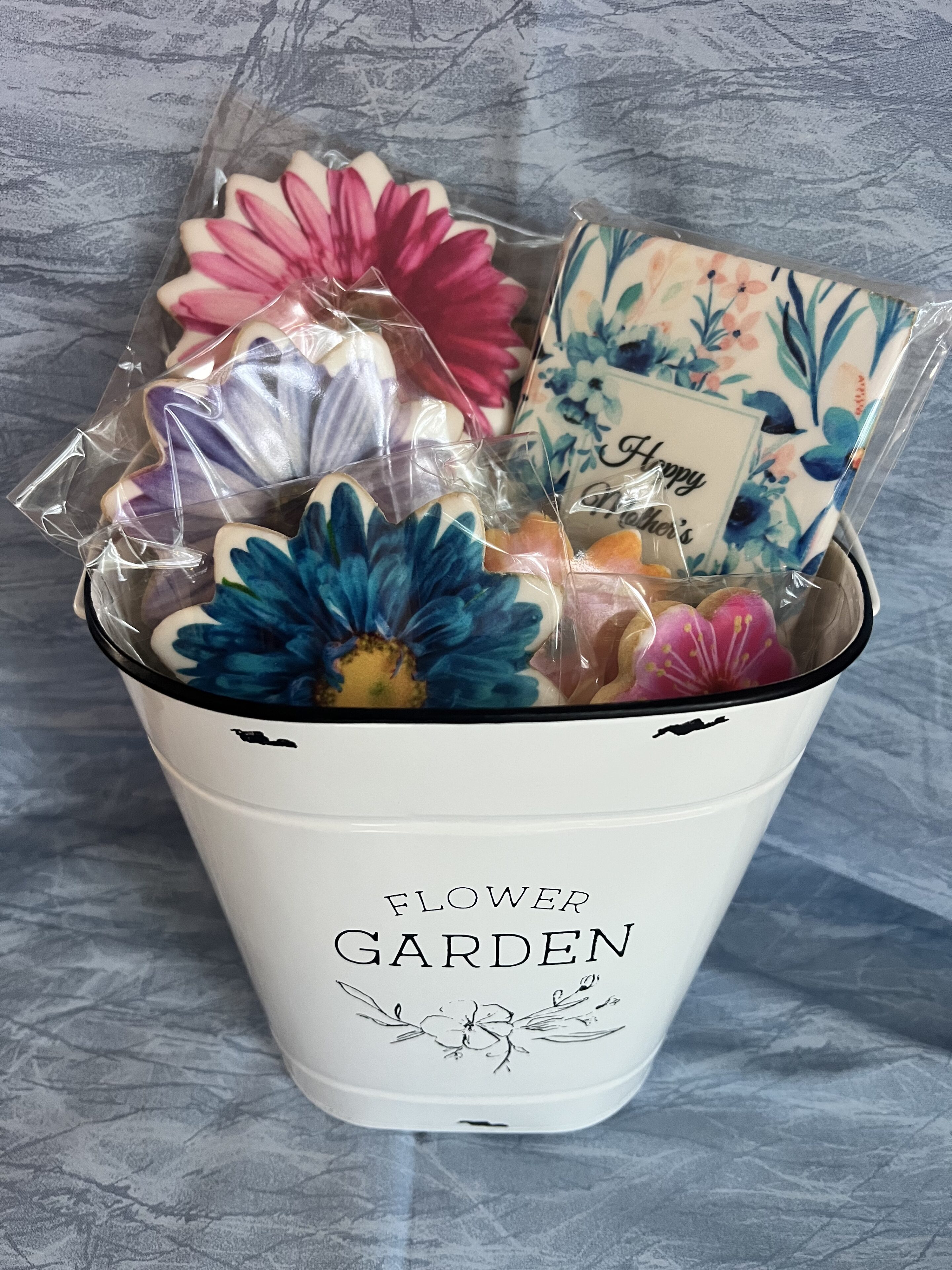 Flower cookies in white garden pot.