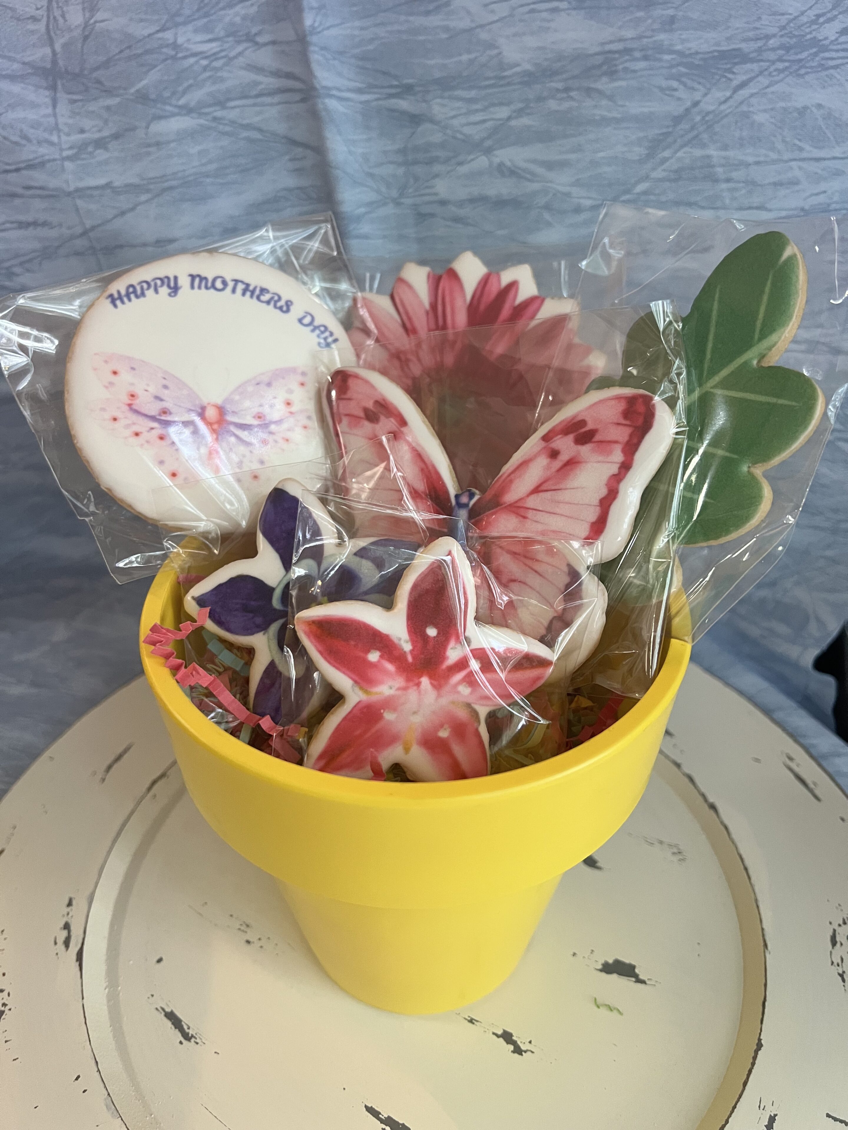 Yellow pot with butterfly-shaped cookies.