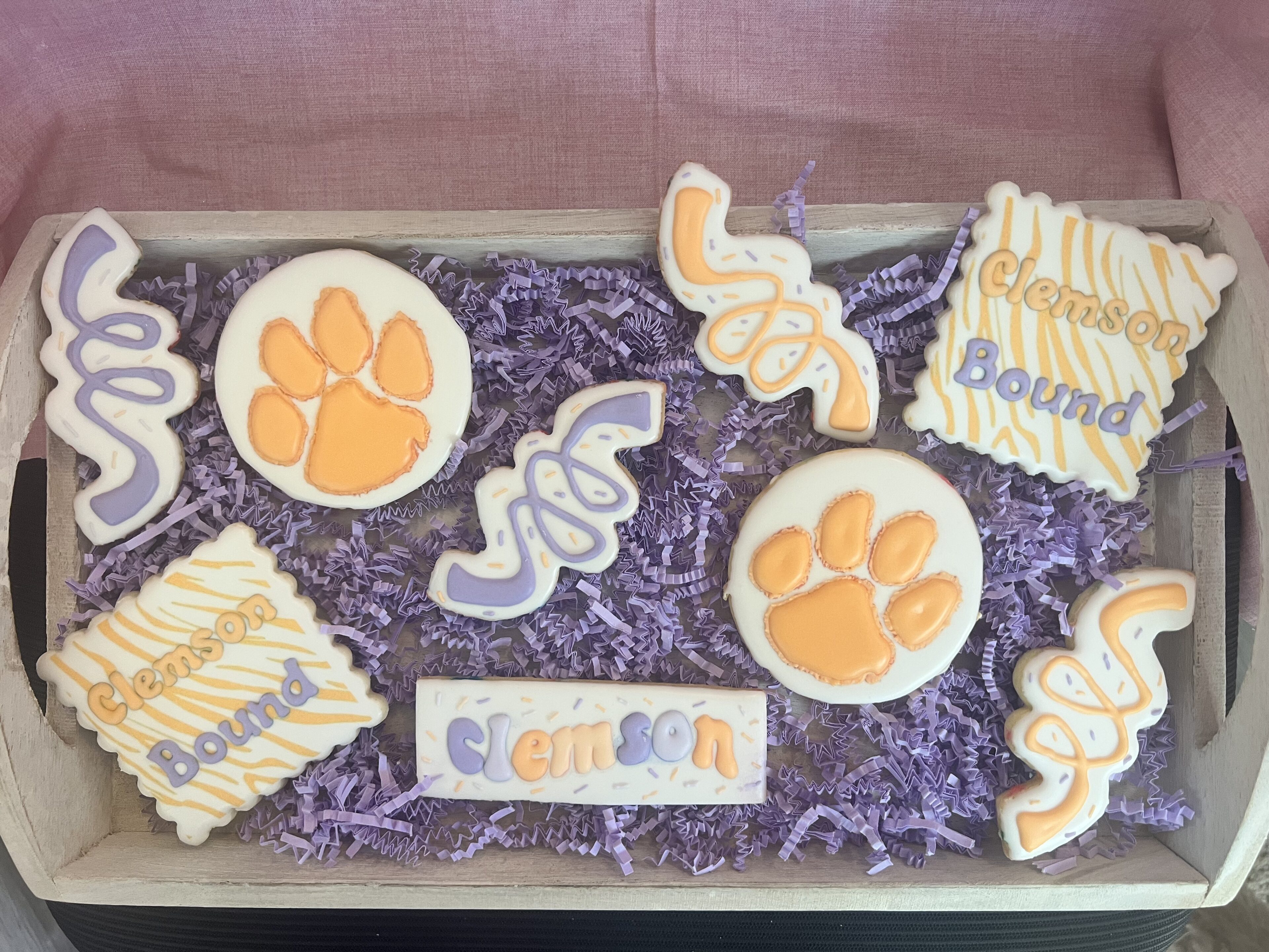Decorative cookies with Clemson theme in tray.